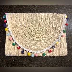 Oversized pompom clutch. New without tags. Never used. Non-smoking home.